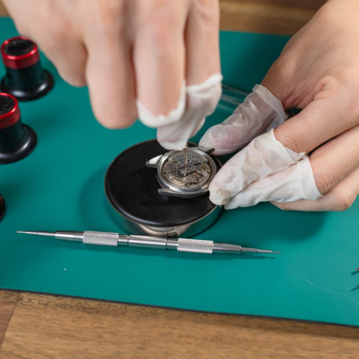 Watchmaker servicing a luxury watch